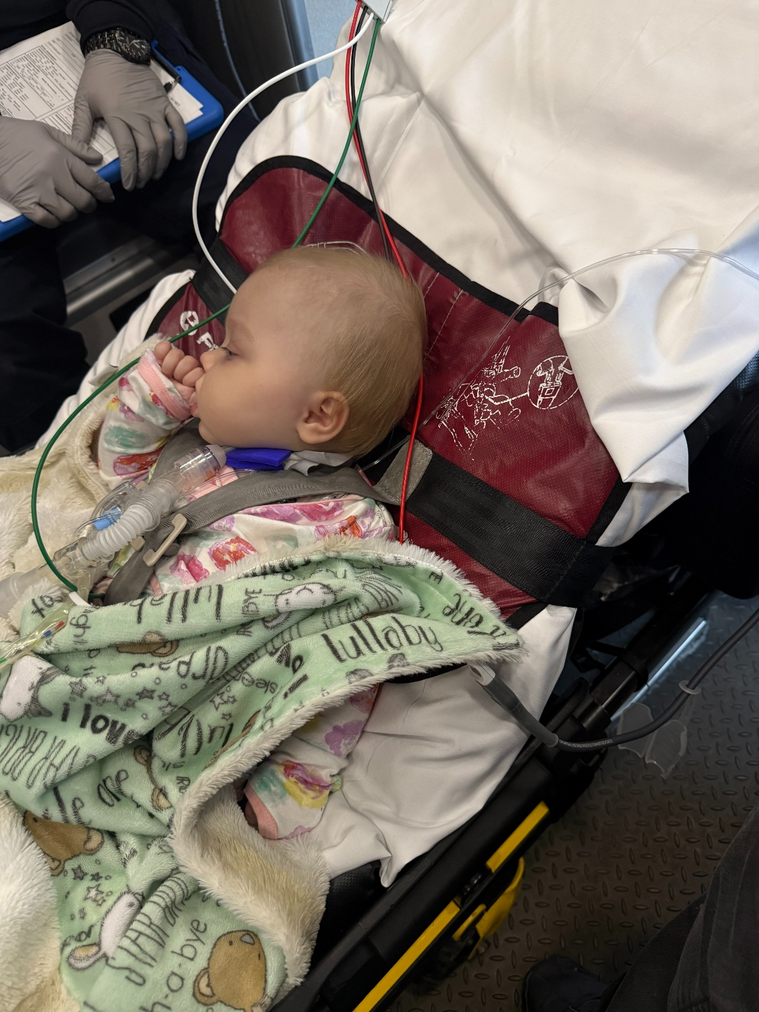 Iris being transported, wrapped in her lullaby blanket