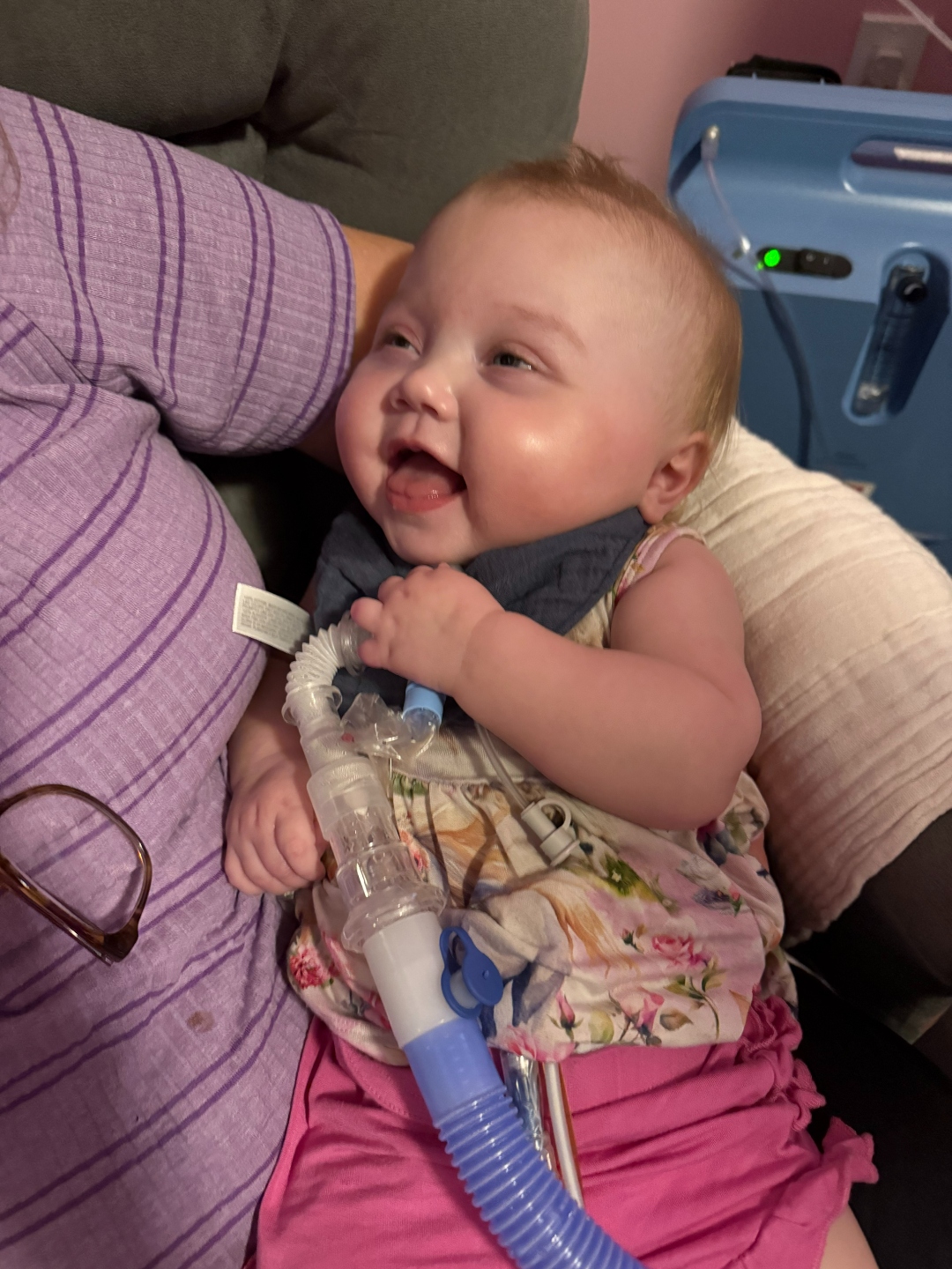 Iris smiling while being held