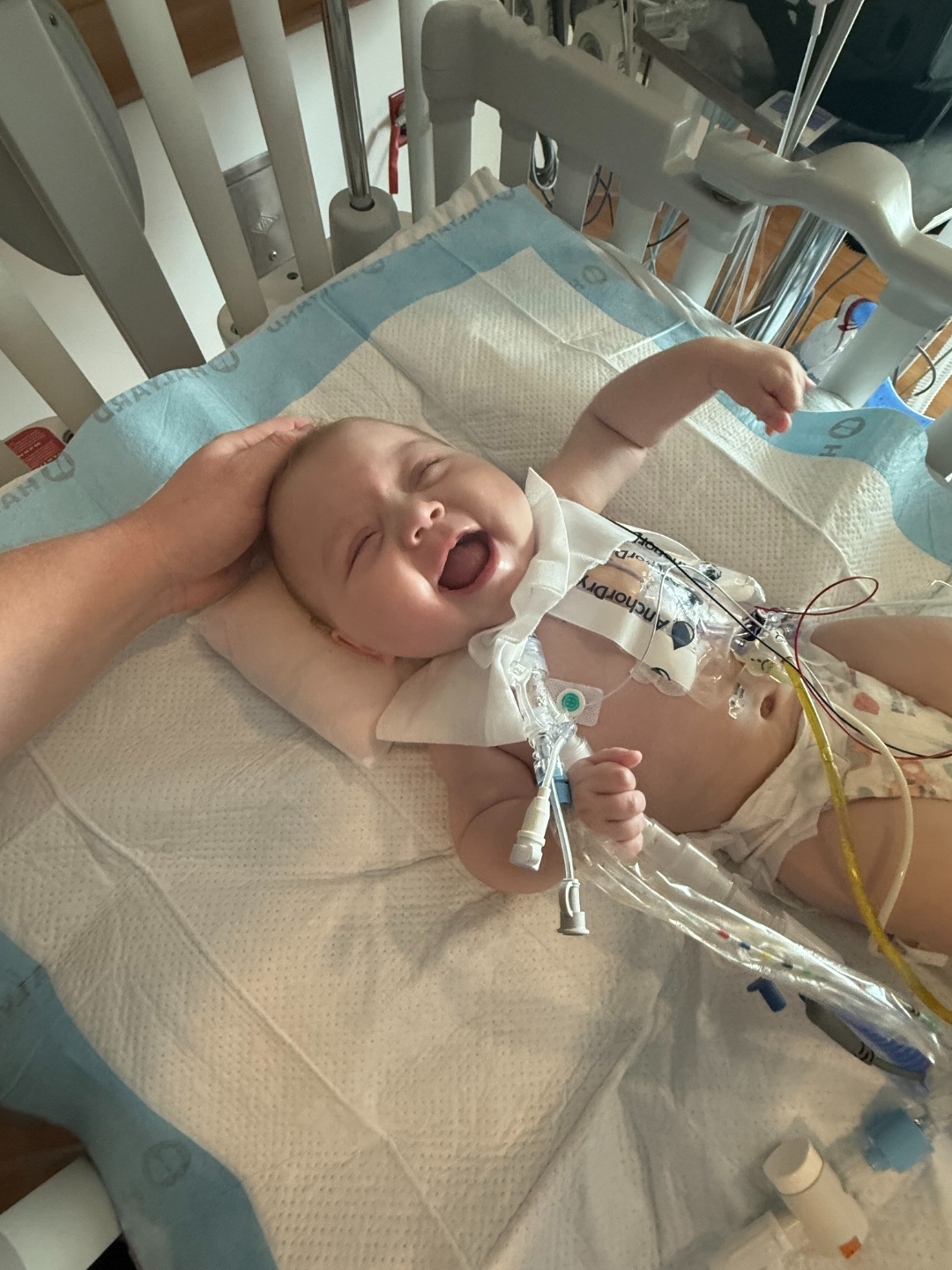 Iris laughing joyfully in her hospital bed